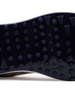 Straight Down Defender Golf Shoe in Camo Stone, close-up outsole detail view featuring navy mixed traction outsole with hexagonal and triangular lug pattern and white midsole edge