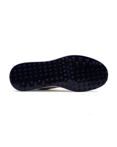 Straight Down Defender Golf Shoe in Camo Stone, bottom sole view featuring navy mixed traction outsole with hexagonal and triangular lugs and white midsole edge