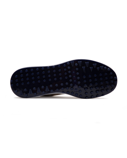 Straight Down Defender Golf Shoe in Camo Stone, bottom sole view featuring navy mixed traction outsole with hexagonal and triangular lugs and white midsole edge