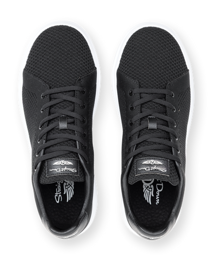 Black sneakers with brand logo on a white background