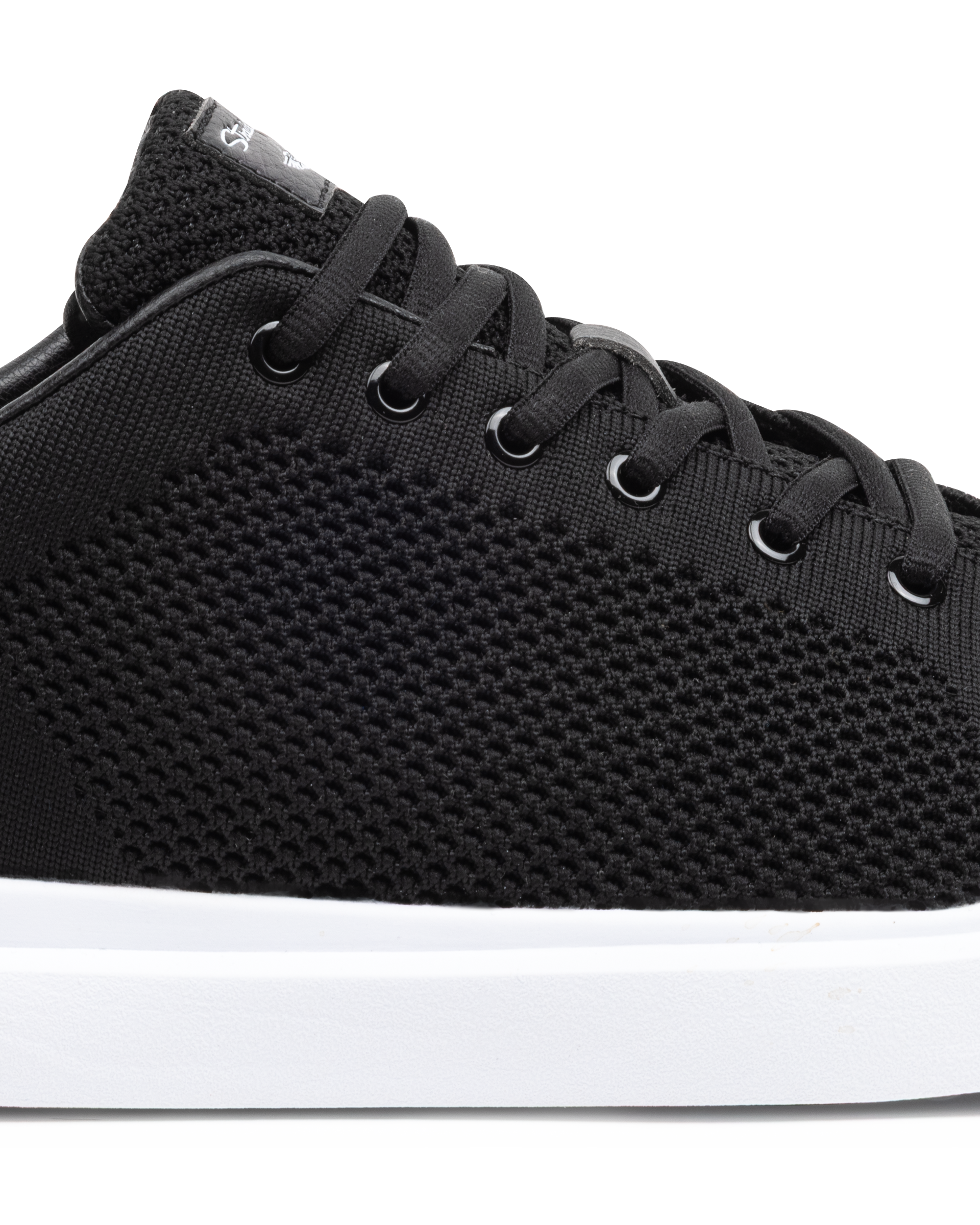 Black sneaker with white sole on a white background