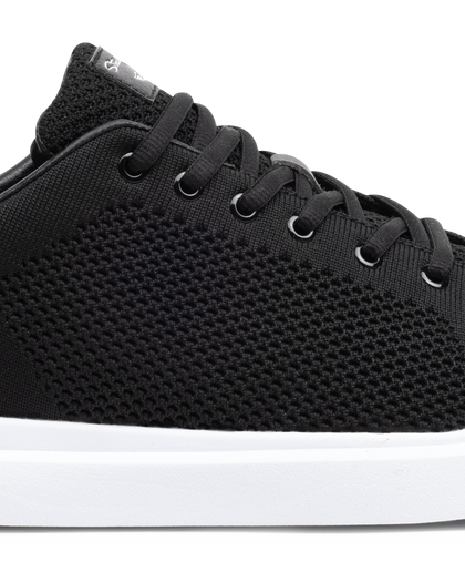 Black sneaker with white sole on a white background