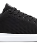 Black sneaker with white sole on a white background