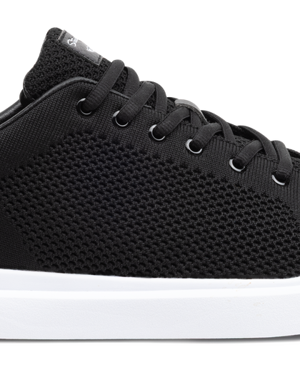 Black sneaker with white sole on a white background