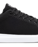 Black sneaker with white sole on a white background