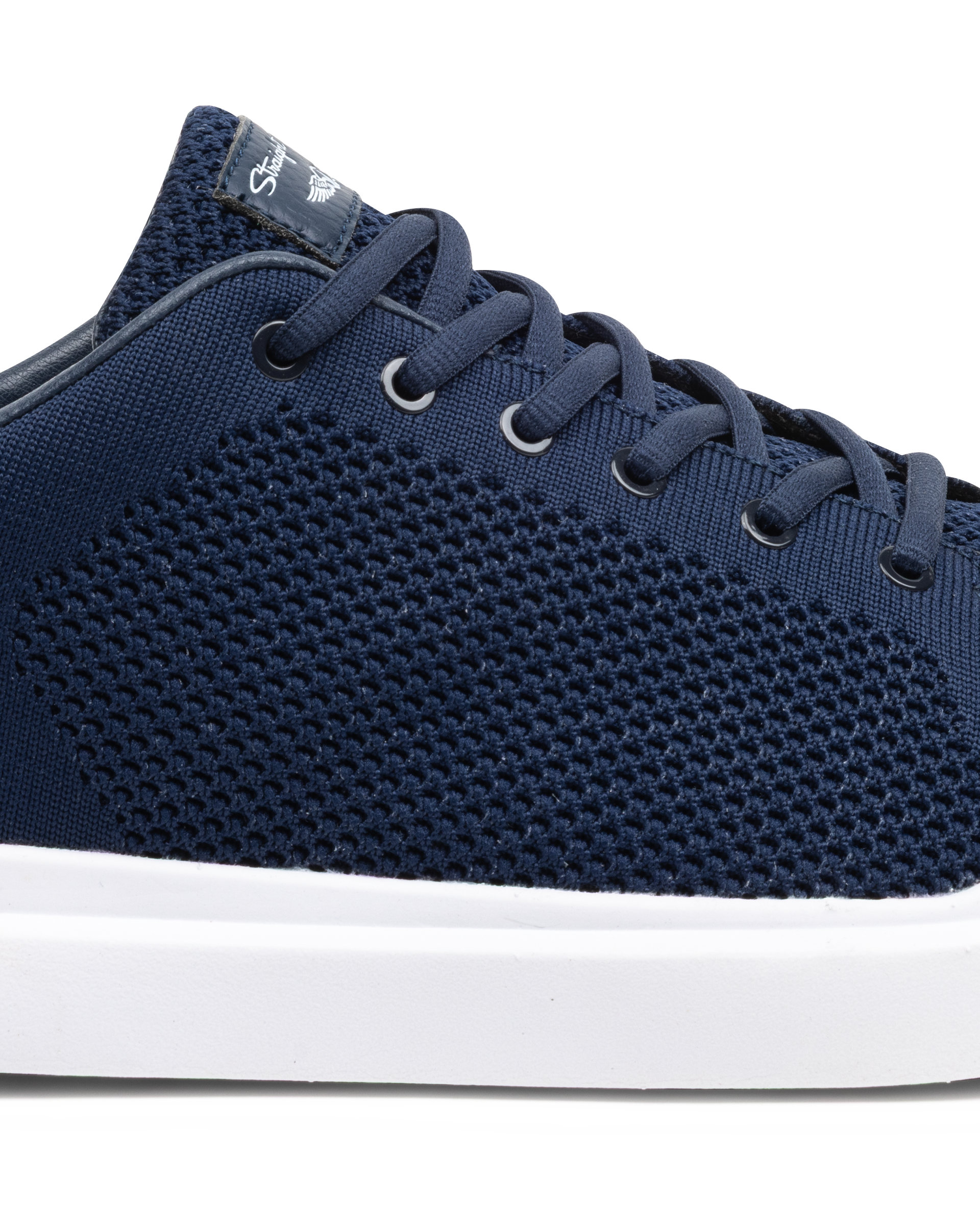 Navy blue sneaker with white sole on a white background