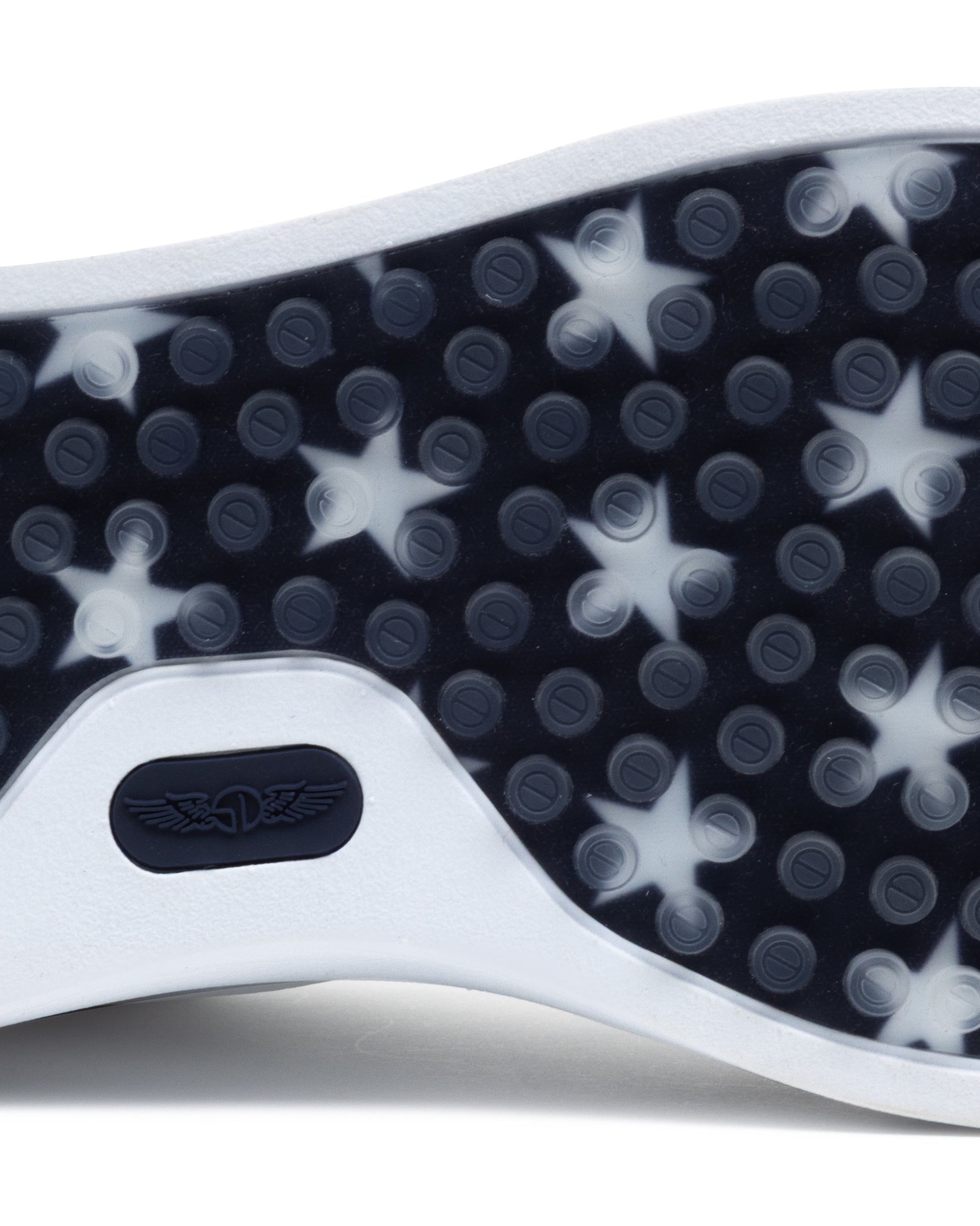 Close-up of a shoe sole with star pattern and brand logo