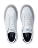 White sneakers with a brand logo on a white background