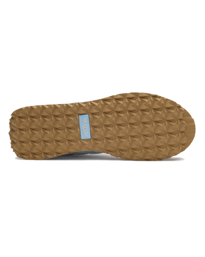 Clubhouse Trainer with white body, red and blue accents, outsole view