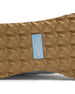 Clubhouse Trainer with white body, red and blue accents, tread detail view