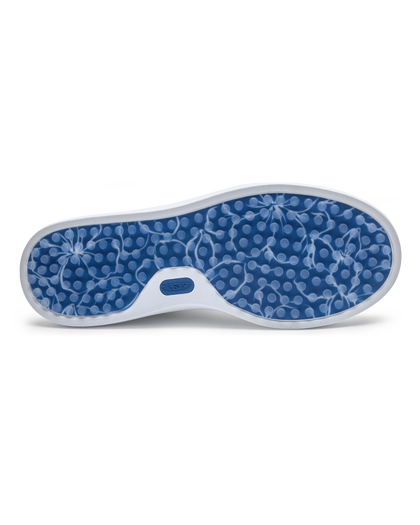 Cruise Perforated Sneaker in White with textured blue outsole, bottom view
