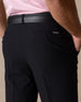 Men's Drake Short in Black, close-up back pocket detail featuring a tonal button-welt pocket with embroidered winged logo tab and black leather belt