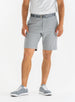 Men's Drake Short in Carbon, front model view featuring a flat-front silhouette in a cool medium gray colorway, styled with a gray belt, white polo, and gray golf shoes