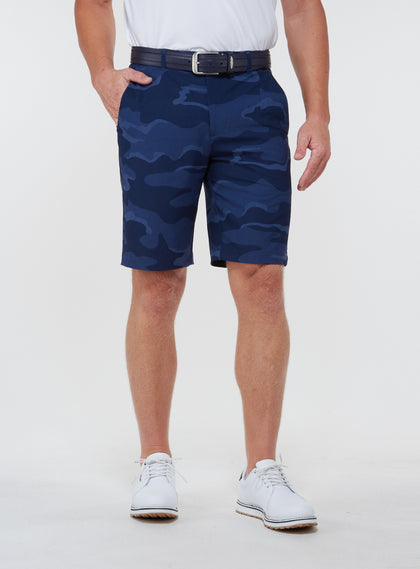 Straight Down Men's Pendleton Short in New Indigo, on model front view showing navy blue camo print paired with a white polo, navy leather belt, and white golf shoes