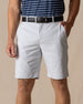 Men's Maverick Twill Short in Silver, front model view featuring a light gray solid twill fabric with side slash pockets and belt loops, styled with a navy striped polo and black belt