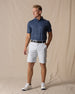 Men's Maverick Twill Short in Silver, full length model view featuring a light gray solid twill fabric with belt loops, styled with a navy striped polo, black belt, and white shoes