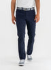 Men's Clemson Pant in Indigo, on-model front view featuring a navy five-pocket style with a button closure and gray belt worn with a white tee and gray golf shoes