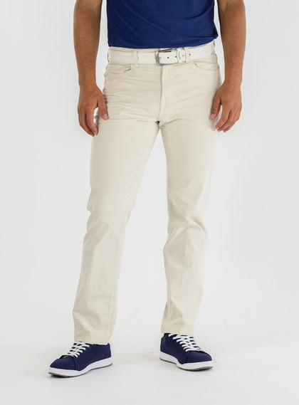Men's Clemson Pant in Stone, on-model front view featuring a light tan five-pocket style with a button closure and white belt worn with a navy polo and navy golf shoes