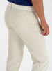 Men's Clemson Pant in Stone, on-model close-up back view featuring a light tan five-pocket style with two rear welt pockets, a tonal embroidered logo, and a white belt