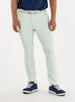 Men's Quest Pant in Light Mint, front on-model view featuring mint green pants with a button waistband closure and side pockets, styled with a navy shirt, white belt, and navy shoes