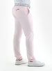 Men's Quest Pant in Light Pink, side and back detail on-model view featuring light pink pants with a button-closure back pocket and small logo tab, styled with a gray belt and white shoes