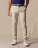  Men's Maverick Twill Pant in Cashew, front view on model featuring a solid cashew color with navy belt and white golf shoes