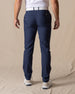 Men's Maverick Twill Pant in New Indigo, back view on model featuring solid navy slim fit golf pants
