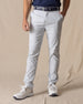 Men's Maverick Twill Pant in Silver, front view on model featuring solid silver slim fit golf pants with navy belt and white golf shoes