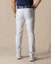 Men's Maverick Twill Pant in Silver, back view on model featuring solid silver slim fit golf pants with navy belt and white golf shoes