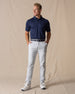 Men's Maverick Twill Pant in Silver, full length front view on model featuring solid silver slim fit golf pants paired with a navy polo, navy belt, and white golf shoes