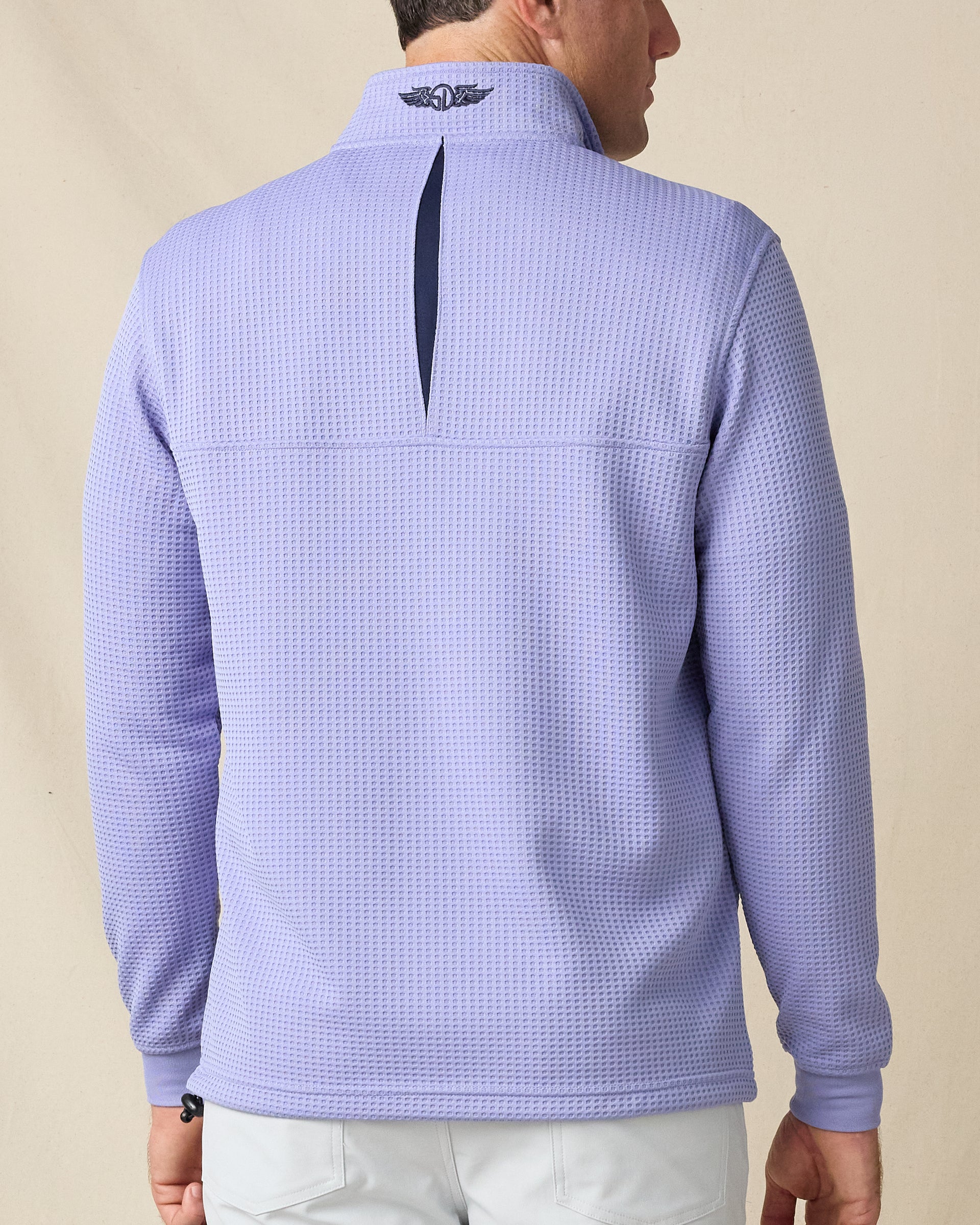 Back view of the Optic Quarter Zip in Blue Shade, highlighting the waffle-knit texture, contrast back detail, and embroidered logo at the collar.