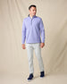 Model wearing the Optic Quarter Zip in Blue Shade with light gray pants and navy sneakers.