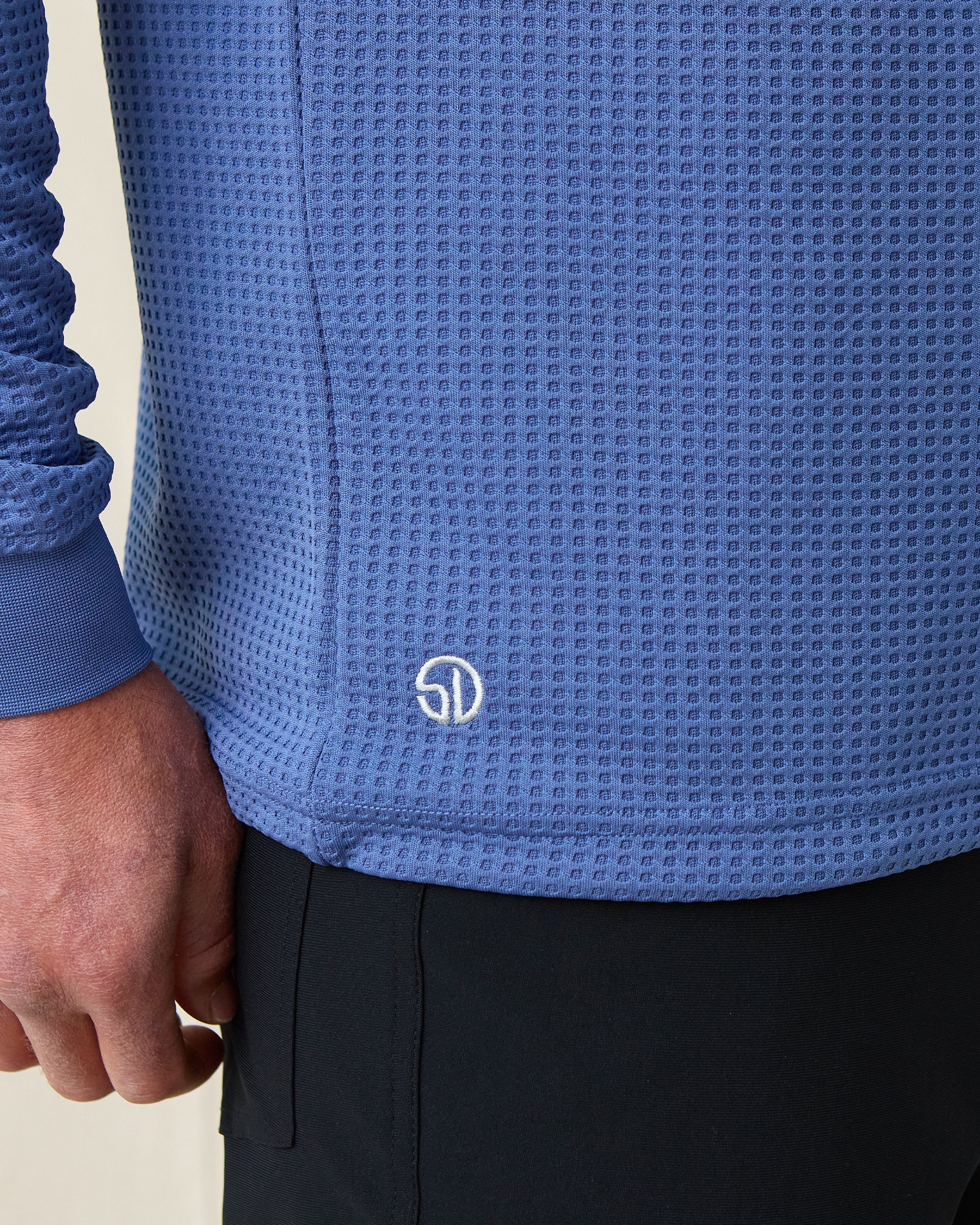 Close-up of Men’s Optic Quarter-Zip in moonlight blue showing embroidered Straight Down logo near hem