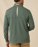 Back view of model wearing the Optic Quarter Zip in Dark Forest, showing the textured waffle knit, contrast back collar detail, and embroidered logo.