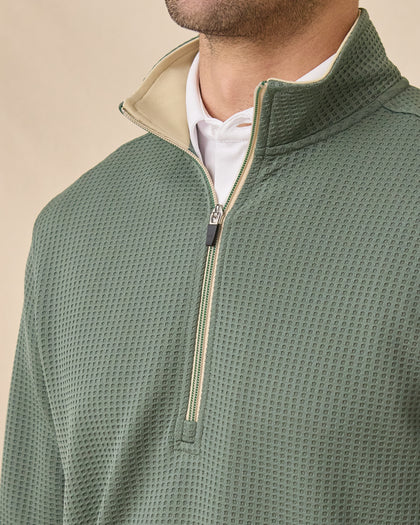 Close-up of the Optic Quarter Zip in Dark Forest showing the waffle-knit texture, beige contrast collar lining, and quarter-zip detail.