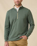 Model wearing the Optic Quarter Zip in Dark Forest over a white polo with tan pants, showing the textured waffle knit and contrast collar.