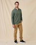 Full-length view of model wearing the Optic Quarter Zip in Dark Forest with tan pants and black sneakers.