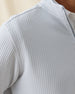 Macro texture detail of the silver Optic Quarter Zip showcasing breathable waffle-knit construction and shoulder seam detail