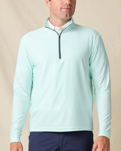 Model wearing the Crusher Quarter Zip in Mint Tea, featuring a clean solid finish with a contrast navy zipper.