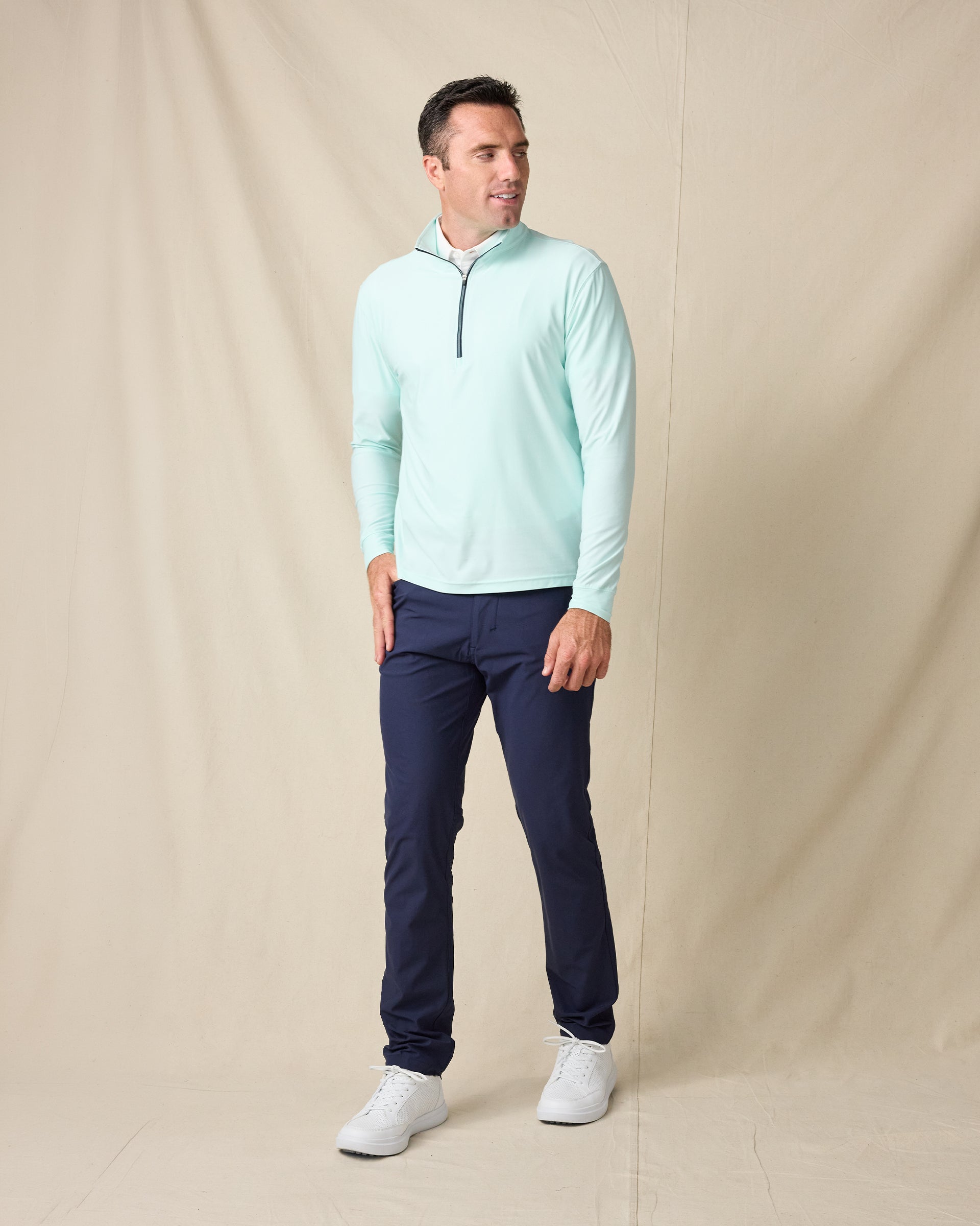 Model wearing the Crusher Quarter Zip in Mint Tea with navy pants and white sneakers.