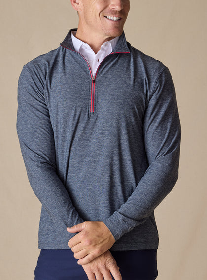Men's Crusher Quarter Zip in New Indigo, front model view featuring a navy heathered body with red contrast quarter-zip closure, layered over a white collared shirt with navy pants