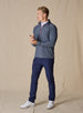 Men's Crusher Quarter Zip in New Indigo, full length model view featuring a navy heathered body with red contrast quarter-zip closure, layered over a white collared shirt, styled with navy pants and white shoes