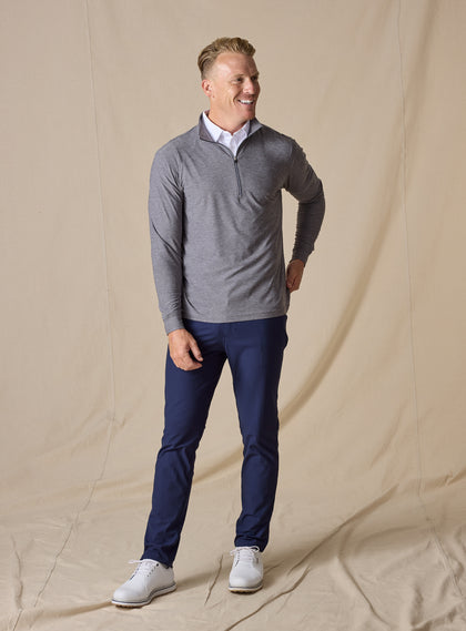 Men's Crusher Quarter Zip in Phantom, full length model view featuring a charcoal heathered body with contrast quarter-zip closure, layered over a white collared shirt, styled with navy pants and white shoes