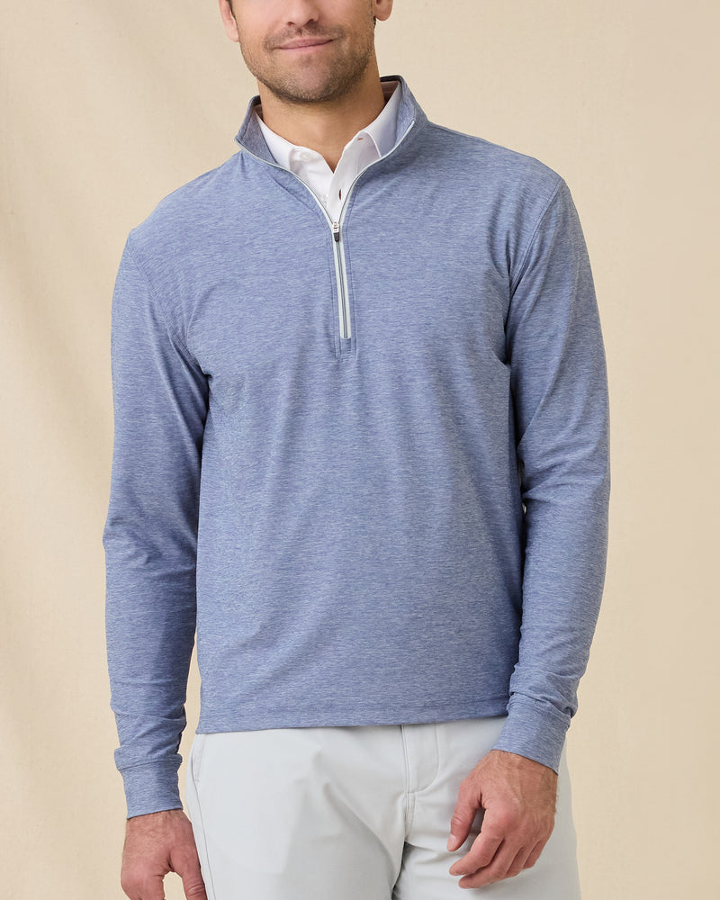 Model wearing the Crusher Quarter Zip in Moonlight over a white polo, showing the heathered fabric and contrast quarter-zip detail.