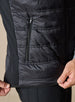 Men's Delta Vest in Black, close-up side detail featuring zip hand pocket, horizontal quilted baffles, and contrast softshell side panel with stretch hem detail
