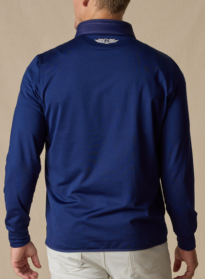 Men's Patton Jacket in Indigo, back on-model view featuring smooth stretch knit fabric with a small embroidered logo at the upper back collar