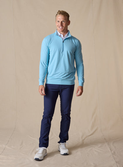 Men's Ballard Quarter Zip in Niagara, on model front view full length styled over a white polo with navy pants and white golf shoes