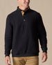 Men's Foothill V2 Placket in Black, on-model front view featuring black fleece fabric, three-button placket with gold suede inner placket trim, layered over a white polo with khaki pants