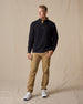 Men's Foothill V2 Placket in Black, full-length on-model lifestyle view featuring black fleece fabric, three-button placket with gold suede trim, styled with khaki pants and white golf shoes