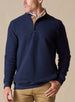 Men's Foothill V2 Placket in Indigo, on-model front view featuring navy fleece fabric, three-button placket with gold suede inner placket trim, layered over a white polo with khaki pants